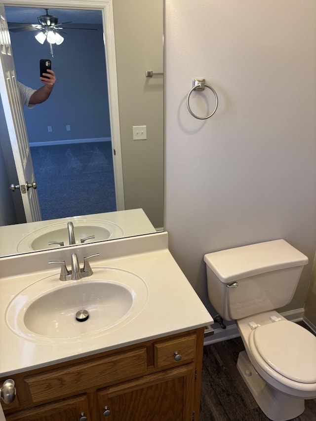 bathroom featuring hardwood / wood-style flooring, vanity, and toilet