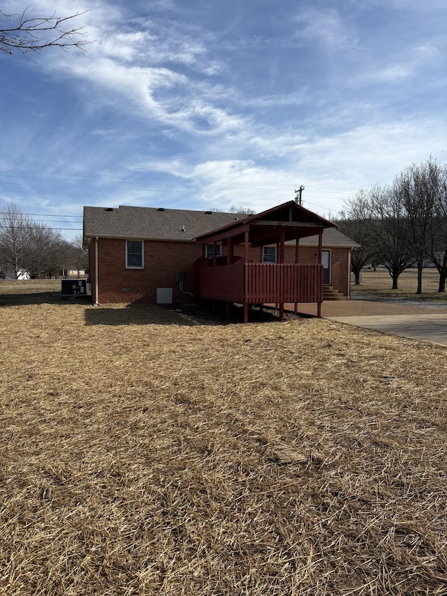 back of property featuring a wooden deck