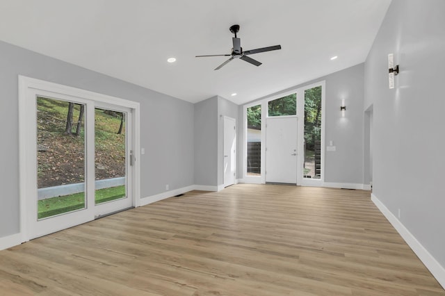 unfurnished living room with lofted ceiling, light hardwood / wood-style floors, and ceiling fan