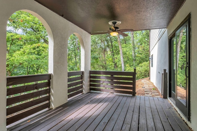 wooden terrace featuring ceiling fan