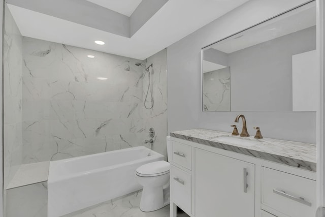 full bathroom featuring vanity, tiled shower / bath, and toilet