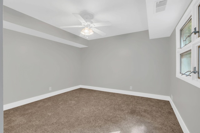 carpeted spare room featuring ceiling fan