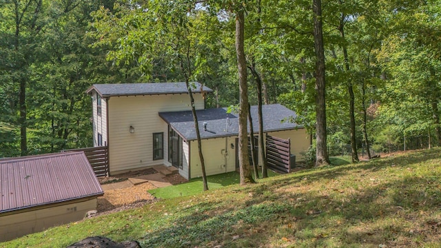 back of house with a lawn