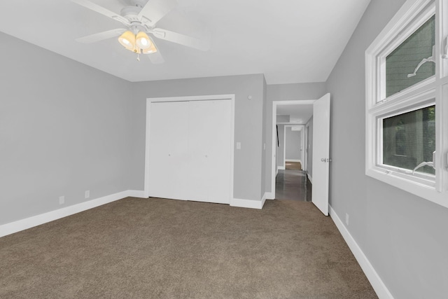 unfurnished bedroom with carpet flooring, ceiling fan, and a closet