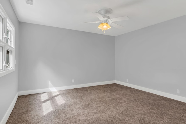 spare room featuring ceiling fan and carpet flooring