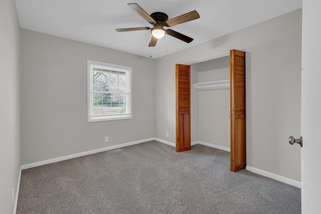 unfurnished bedroom with carpet floors, ceiling fan, and a closet