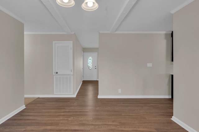 spare room with dark hardwood / wood-style flooring, crown molding, and beamed ceiling