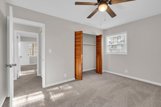 unfurnished bedroom with light carpet, ceiling fan, and a closet