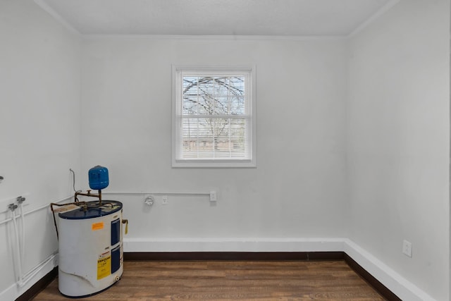 interior space featuring crown molding, dark wood-type flooring, and electric water heater