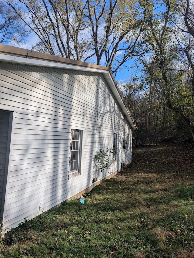 view of side of property with a yard