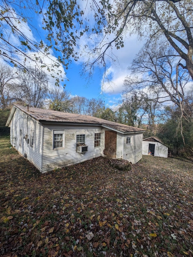 rear view of house featuring cooling unit