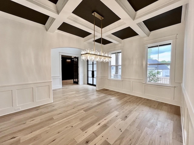 interior space featuring coffered ceiling, a chandelier, beamed ceiling, and light wood-type flooring