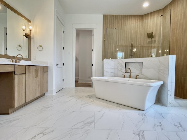 bathroom featuring vanity and independent shower and bath