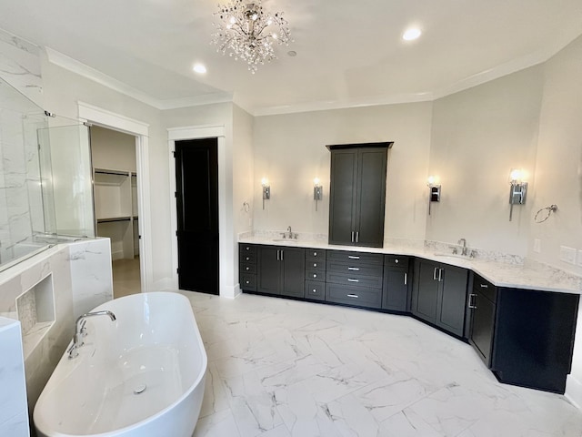 bathroom with vanity, ornamental molding, and a tub