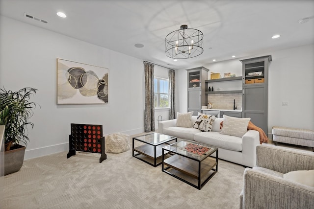 living room with light colored carpet and a chandelier