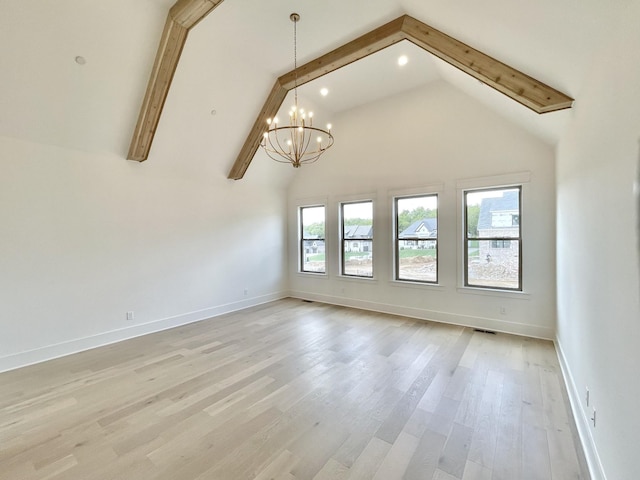 empty room featuring a wealth of natural light, a chandelier, beamed ceiling, and light wood-type flooring