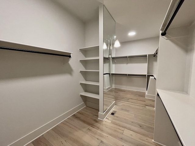 spacious closet featuring light hardwood / wood-style flooring