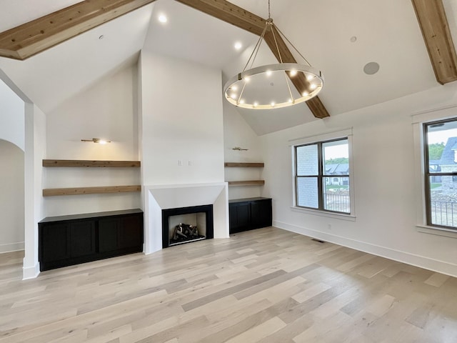 unfurnished living room with beamed ceiling, high vaulted ceiling, and light hardwood / wood-style flooring