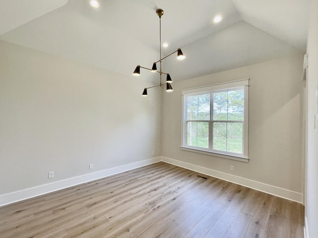 unfurnished room with vaulted ceiling and light hardwood / wood-style floors