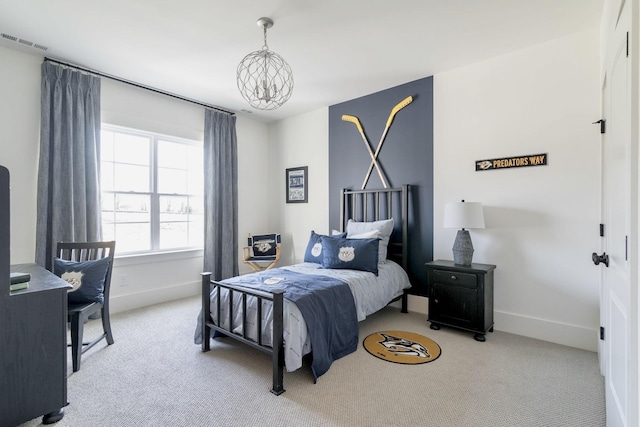 carpeted bedroom featuring a notable chandelier