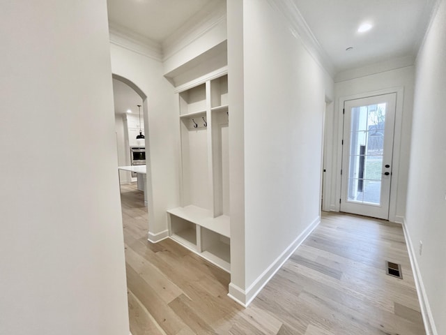 mudroom with crown molding and light wood-type flooring