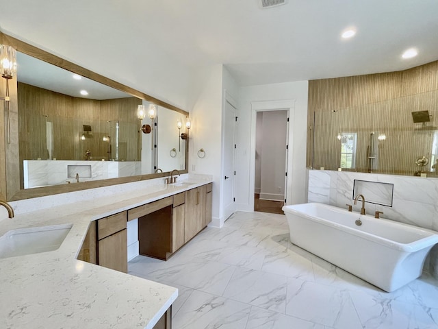 bathroom with vanity and shower with separate bathtub