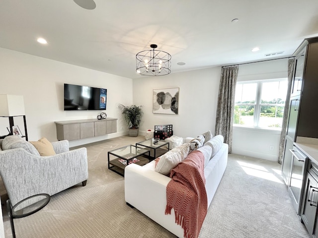 carpeted living room with a chandelier