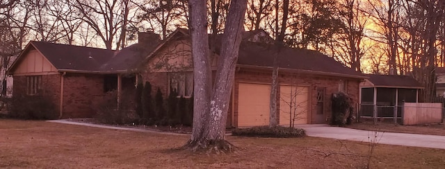 exterior space featuring a garage and a sunroom