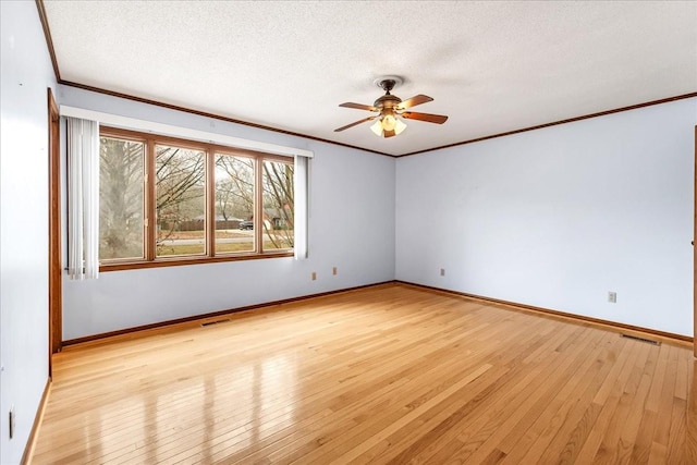 spare room with ceiling fan, light hardwood / wood-style flooring, ornamental molding, and a textured ceiling