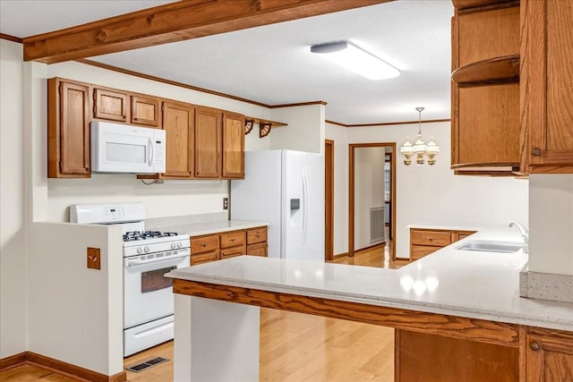 kitchen with sink, hanging light fixtures, ornamental molding, white appliances, and light hardwood / wood-style floors