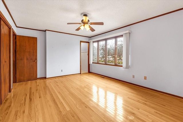 unfurnished bedroom with light hardwood / wood-style flooring, ceiling fan, ornamental molding, a textured ceiling, and a closet