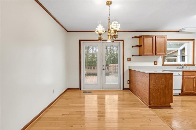 kitchen with pendant lighting, ornamental molding, dishwasher, and light hardwood / wood-style floors