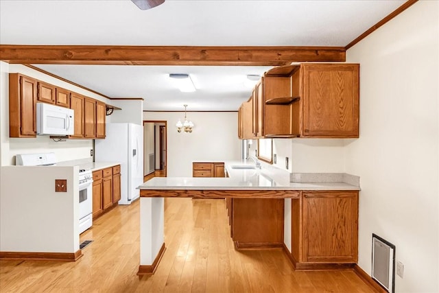 kitchen featuring decorative light fixtures, sink, kitchen peninsula, white appliances, and light hardwood / wood-style flooring