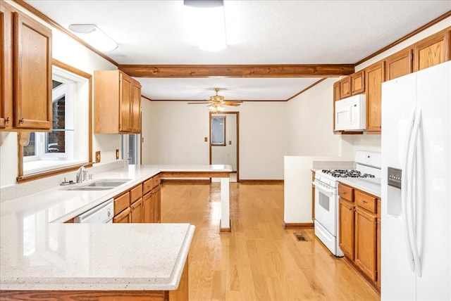 kitchen featuring white appliances, kitchen peninsula, sink, and light hardwood / wood-style flooring