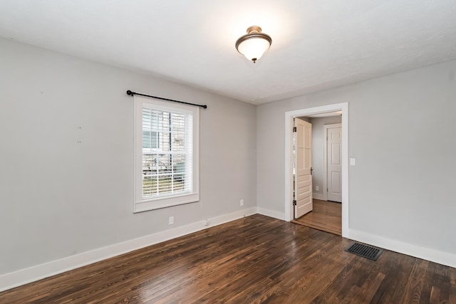 unfurnished room featuring dark hardwood / wood-style flooring