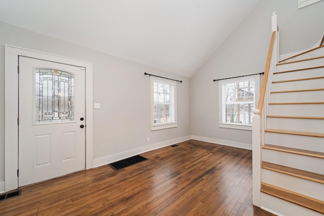 entryway featuring lofted ceiling and dark wood-type flooring