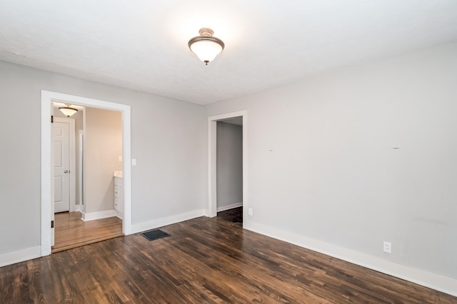 empty room featuring dark wood-type flooring