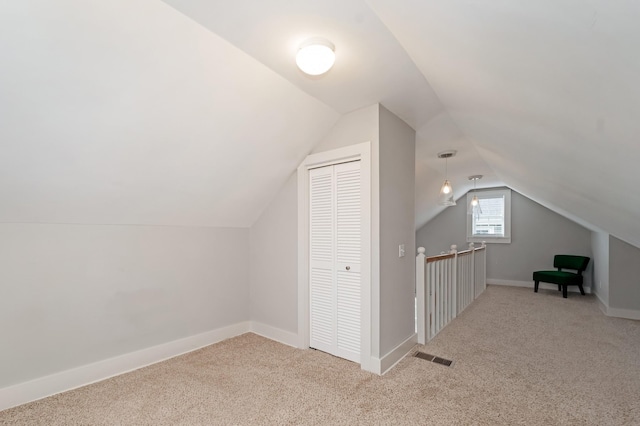 bonus room featuring lofted ceiling and light colored carpet