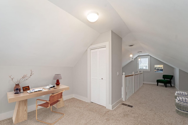 carpeted office space featuring vaulted ceiling