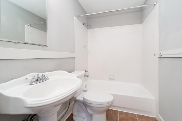 full bathroom with tile patterned flooring,  shower combination, sink, and toilet