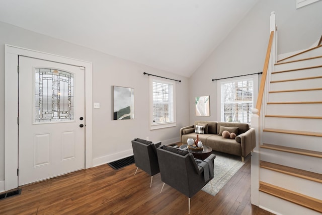 living room featuring lofted ceiling and dark wood-type flooring