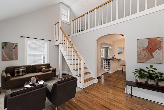 living room featuring hardwood / wood-style flooring and high vaulted ceiling