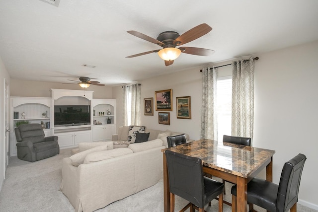 carpeted living room featuring ceiling fan