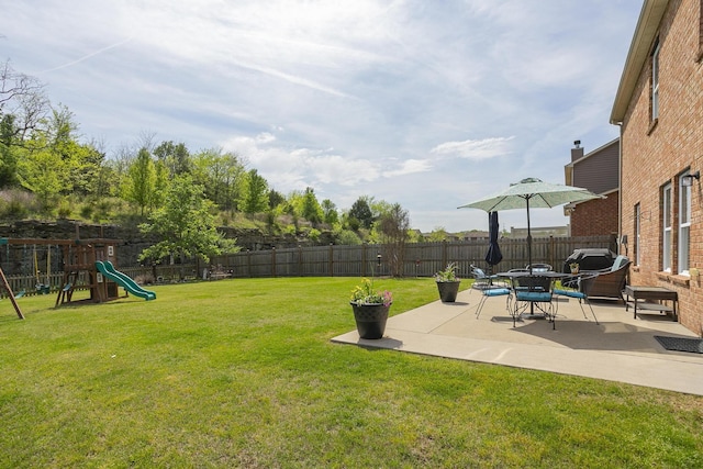 view of yard featuring a playground and a patio area