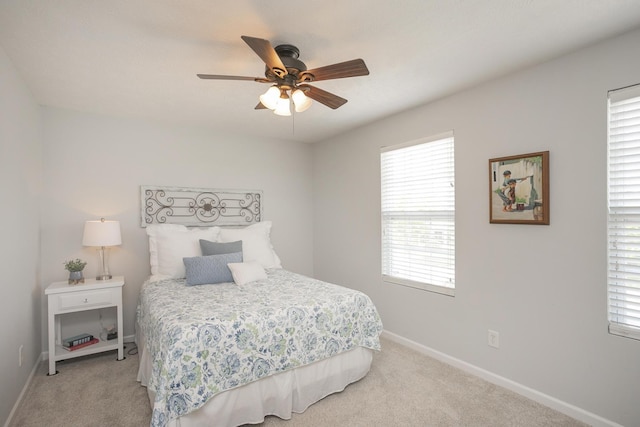 bedroom featuring light colored carpet and ceiling fan