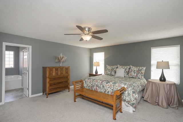 carpeted bedroom featuring connected bathroom and ceiling fan