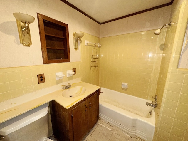 bathroom featuring ornamental molding, tile patterned floors,  shower combination, vanity, and tile walls