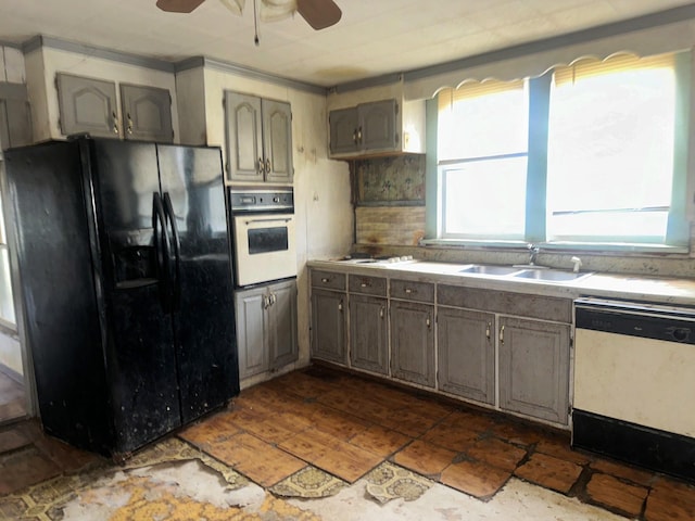 kitchen featuring white appliances, backsplash, a sink, and a wealth of natural light