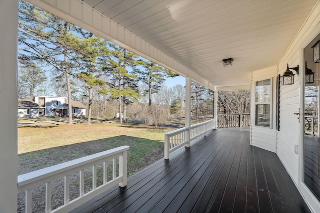 wooden terrace with a porch and a lawn