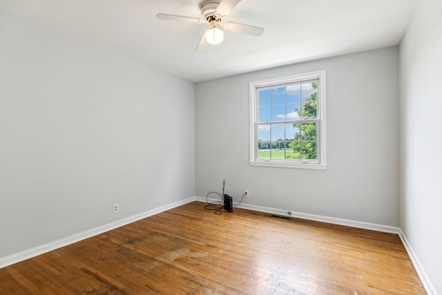 empty room featuring wood-type flooring and ceiling fan